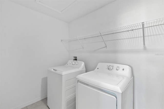 8656 40th Cir E, Palmetto, FL 34221 - laundry room featuring washing machine and clothes dryer, light tile patterned floors, and baseboards