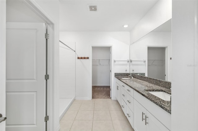 8656 40th Cir E, Palmetto, FL 34221 - full bathroom featuring a walk in closet, a stall shower, double vanity, tile patterned floors, and recessed lighting