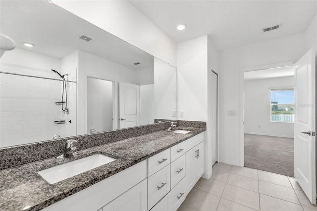 8656 40th Cir E, Palmetto, FL 34221 - full bathroom featuring double vanity, tile patterned flooring, baseboards, tiled shower, and recessed lighting