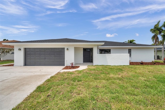 5125 Palm Aire Dr, Sarasota, FL 34243 - view of front of house featuring driveway, an attached garage, stucco siding, and a front yard