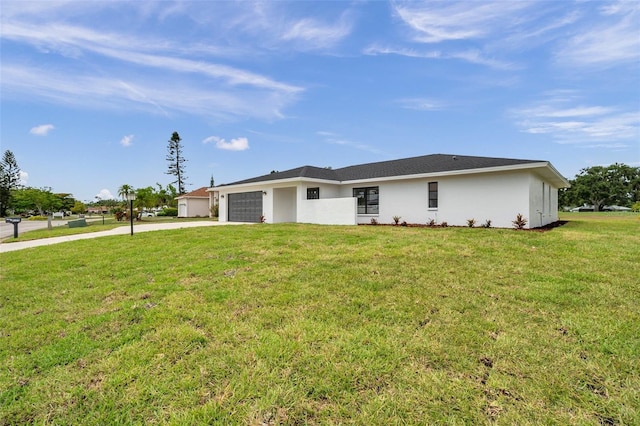5125 Palm Aire Dr, Sarasota, FL 34243 - view of front of property featuring driveway, an attached garage, a front yard, and stucco siding
