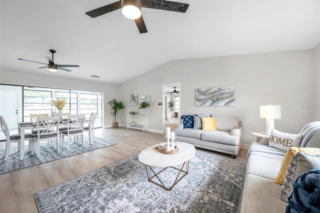 5125 Palm Aire Dr, Sarasota, FL 34243 - living area featuring a ceiling fan, wood finished floors, lofted ceiling, and baseboards