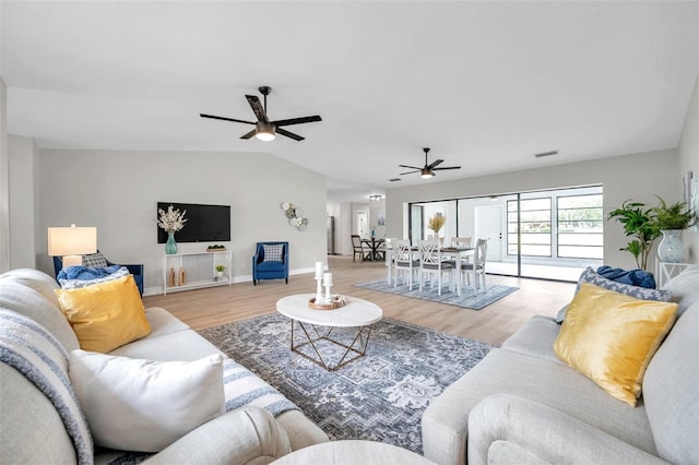 5125 Palm Aire Dr, Sarasota, FL 34243 - living room featuring a ceiling fan, light wood-style flooring, baseboards, and vaulted ceiling