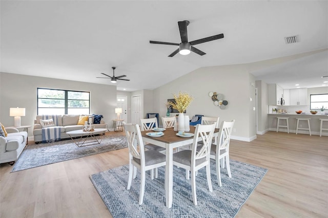 5125 Palm Aire Dr, Sarasota, FL 34243 - dining space featuring a ceiling fan, plenty of natural light, light wood-type flooring, lofted ceiling, and baseboards