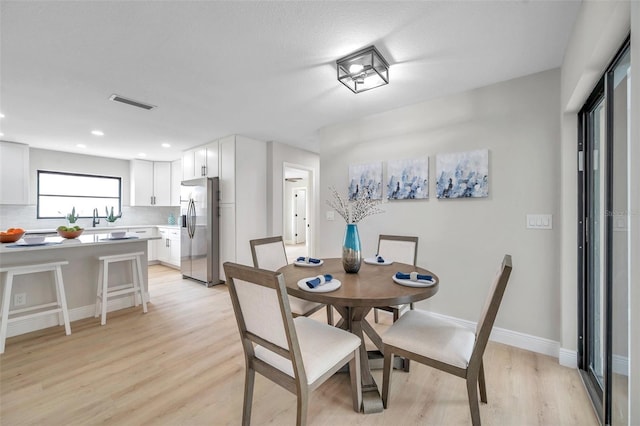 5125 Palm Aire Dr, Sarasota, FL 34243 - dining space with light wood-type flooring, recessed lighting, and baseboards