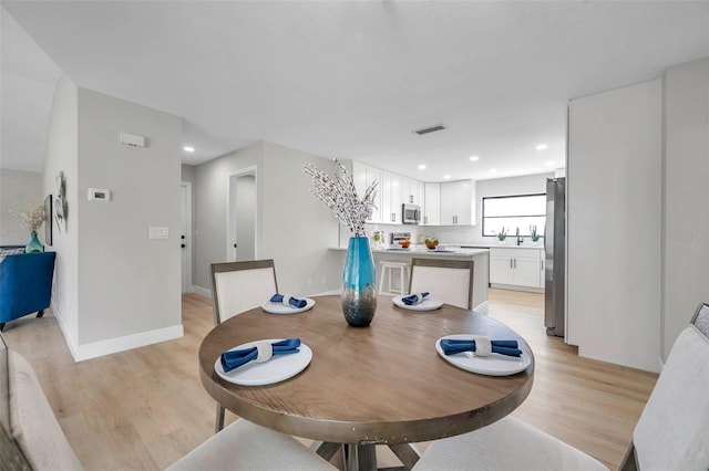 5125 Palm Aire Dr, Sarasota, FL 34243 - dining area featuring light wood-style flooring, recessed lighting, and baseboards