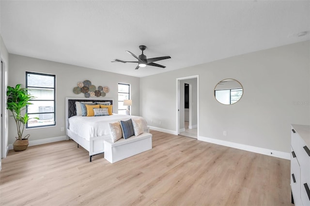 5125 Palm Aire Dr, Sarasota, FL 34243 - unfurnished bedroom with multiple windows, light wood-style floors, and baseboards
