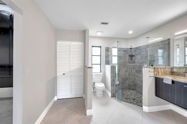 5125 Palm Aire Dr, Sarasota, FL 34243 - bathroom with toilet, vanity, a stall shower, baseboards, and a closet