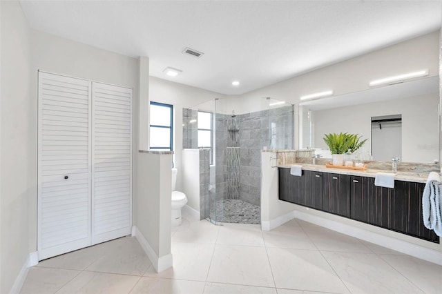 5125 Palm Aire Dr, Sarasota, FL 34243 - bathroom featuring double vanity, toilet, a stall shower, baseboards, and a closet
