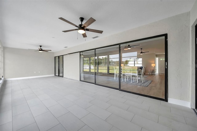 5125 Palm Aire Dr, Sarasota, FL 34243 - spare room featuring a ceiling fan, baseboards, and light tile patterned floors