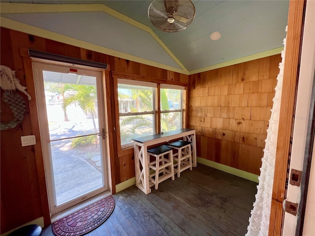 4412 125th St W, Cortez, FL 34215 - dining room with wood walls, lofted ceiling, dark wood-style flooring, and baseboards