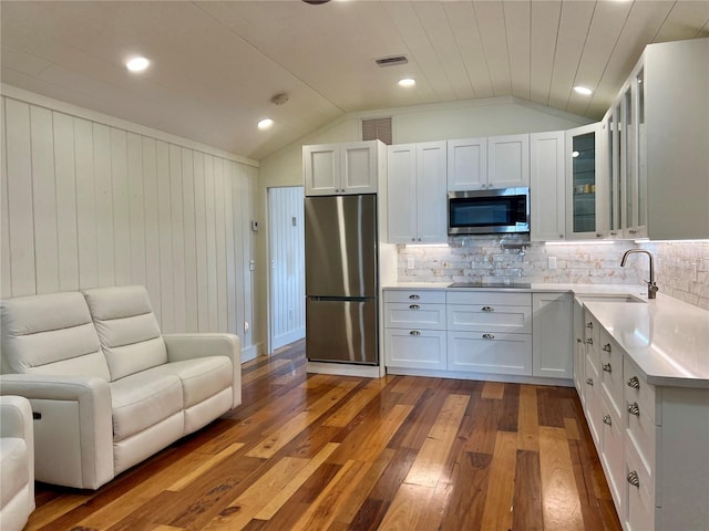 4412 125th St W, Cortez, FL 34215 - kitchen with appliances with stainless steel finishes, a sink, dark wood-type flooring, vaulted ceiling, and open floor plan