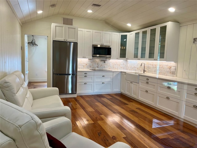 4412 125th St W, Cortez, FL 34215 - kitchen with appliances with stainless steel finishes, a sink, vaulted ceiling, light countertops, and white cabinetry