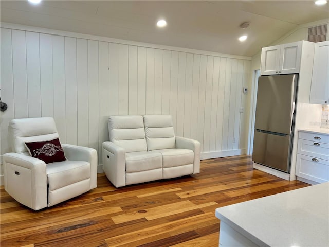 4412 125th St W, Cortez, FL 34215 - living area with light wood-style floors and wooden walls
