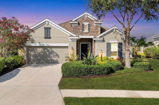 12908 Crystal Clear Pl, Bradenton, FL 34211 - traditional-style home with stucco siding, stone siding, concrete driveway, and a garage