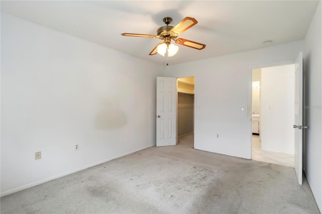 5062 White Oak Ct, Bradenton, FL 34207 - unfurnished bedroom with light colored carpet, a walk in closet, ceiling fan, and a closet