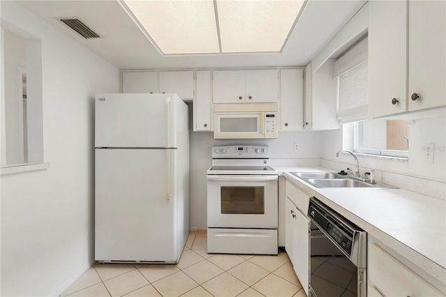 5062 White Oak Ct, Bradenton, FL 34207 - kitchen featuring white appliances, a sink, light countertops, white cabinets, and light tile patterned flooring