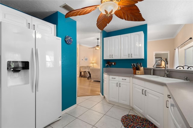 4222 Lanai Dr, Sarasota, FL 34241 - kitchen featuring white appliances, ceiling fan, white cabinetry, crown molding, and a sink
