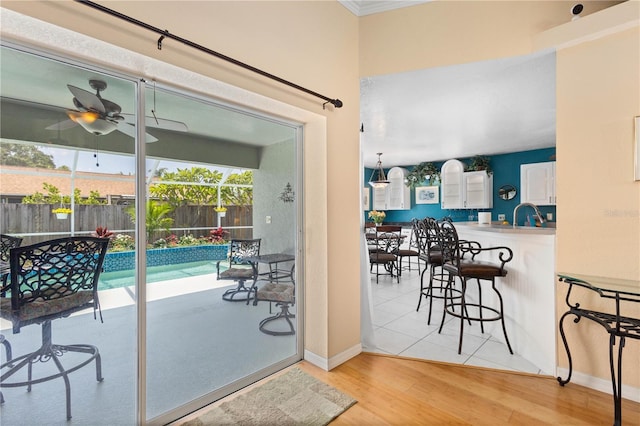 4222 Lanai Dr, Sarasota, FL 34241 - doorway featuring healthy amount of natural light, light wood-style flooring, a ceiling fan, and baseboards