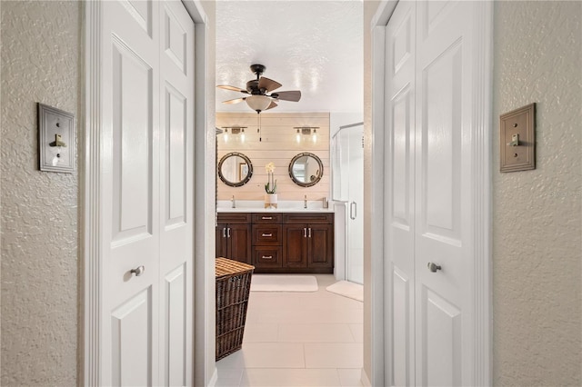 4222 Lanai Dr, Sarasota, FL 34241 - hallway featuring a textured wall, a sink, and light tile patterned floors