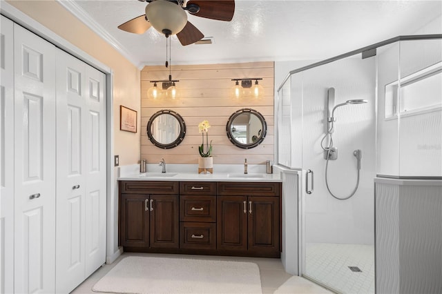 4222 Lanai Dr, Sarasota, FL 34241 - bathroom featuring a shower stall, ceiling fan, double vanity, crown molding, and tile patterned floors