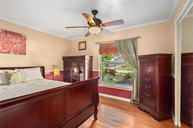 4222 Lanai Dr, Sarasota, FL 34241 - bedroom with light wood finished floors, baseboards, ornamental molding, and ceiling fan