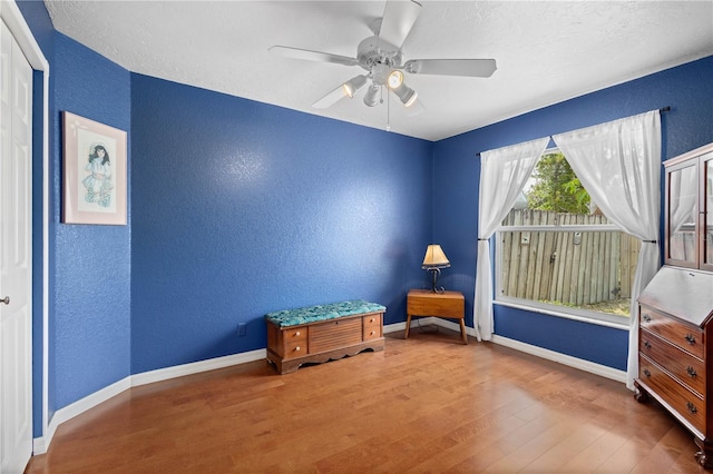 4222 Lanai Dr, Sarasota, FL 34241 - unfurnished room featuring a textured wall, wood finished floors, ceiling fan, baseboards, and a textured ceiling