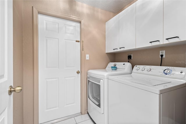 4222 Lanai Dr, Sarasota, FL 34241 - laundry area featuring cabinet space, separate washer and dryer, and light tile patterned floors