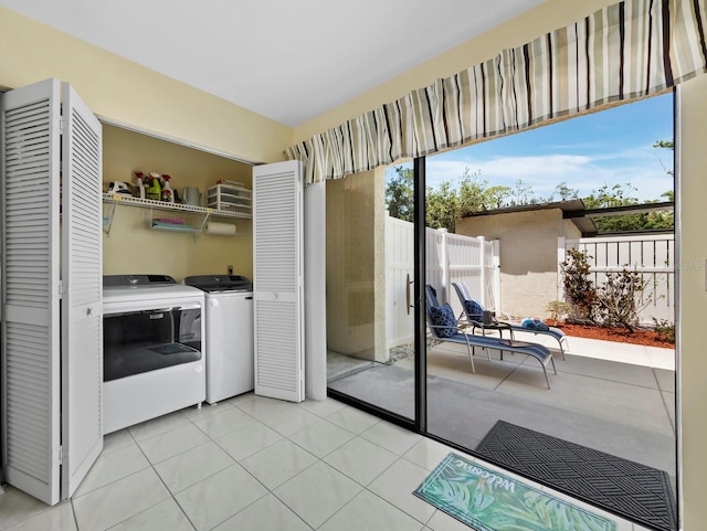 6110 Country Club Way Unit 102, Sarasota, FL 34243 - washroom with separate washer and dryer and light tile patterned floors