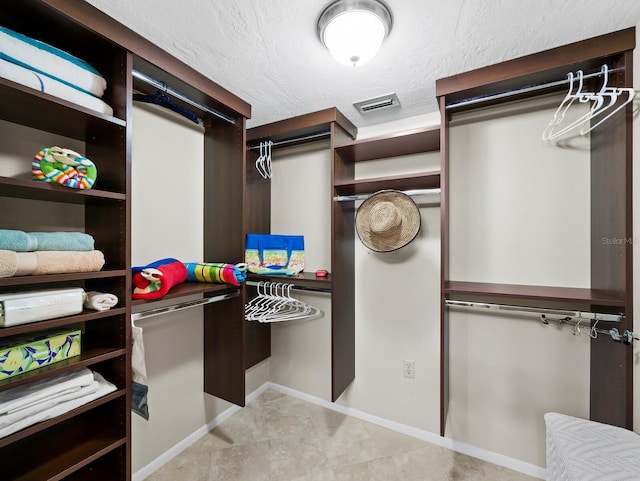 6110 Country Club Way Unit 102, Sarasota, FL 34243 - walk in closet with light tile patterned floors
