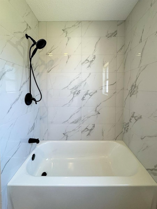 2420 16th St W, Palmetto, FL 34221 - full bathroom featuring a textured ceiling and  shower combination