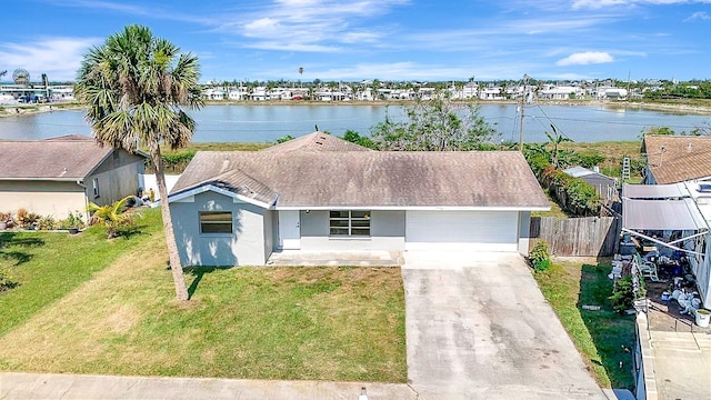 2420 16th St W, Palmetto, FL 34221 - ranch-style house featuring driveway, a water view, and stucco siding