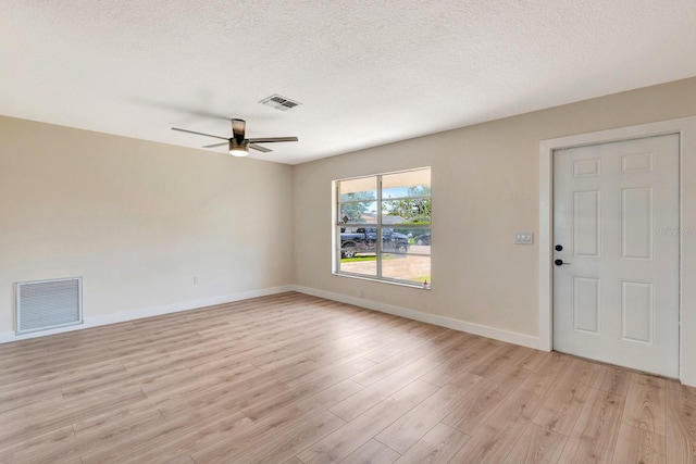2420 16th St W, Palmetto, FL 34221 - empty room with light wood-type flooring, ceiling fan, baseboards, and a textured ceiling