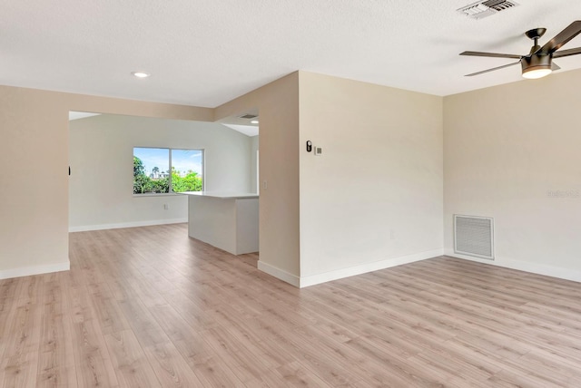 2420 16th St W, Palmetto, FL 34221 - spare room with light wood-style flooring, a ceiling fan, baseboards, recessed lighting, and a textured ceiling