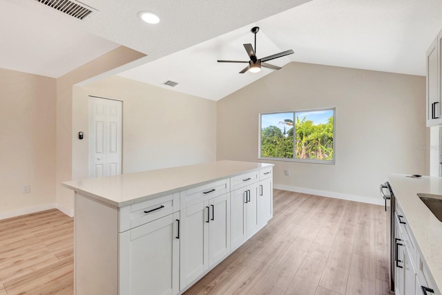 2420 16th St W, Palmetto, FL 34221 - kitchen with ceiling fan, light wood-style flooring, light countertops, lofted ceiling, and baseboards