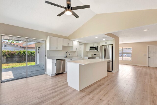 2420 16th St W, Palmetto, FL 34221 - kitchen featuring appliances with stainless steel finishes, a sink, light countertops, a ceiling fan, and a kitchen island