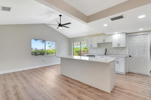 2420 16th St W, Palmetto, FL 34221 - kitchen with a sink, light countertops, ceiling fan, a center island, and light wood-type flooring