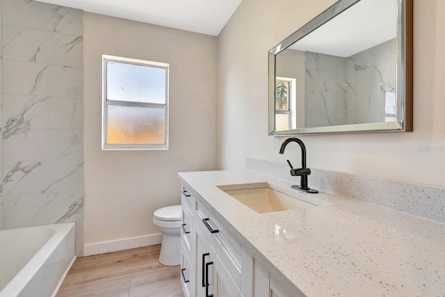 2420 16th St W, Palmetto, FL 34221 - full bath with vanity, toilet, wood finished floors, and baseboards