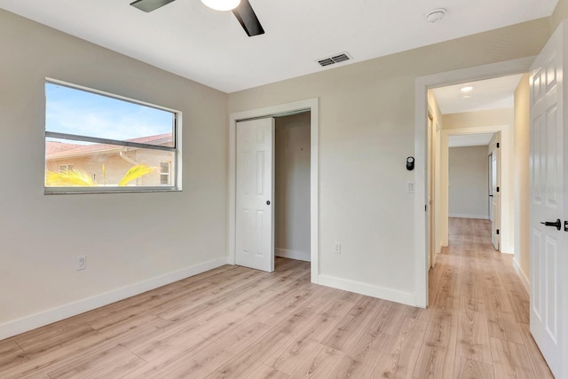 2420 16th St W, Palmetto, FL 34221 - unfurnished bedroom with light wood-style flooring, baseboards, a closet, and a ceiling fan