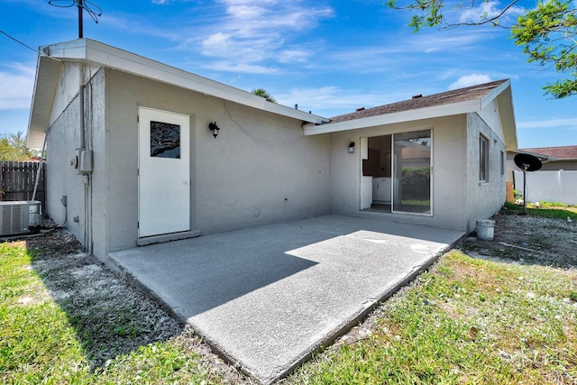 2420 16th St W, Palmetto, FL 34221 - rear view of property with stucco siding, a patio area, and central AC