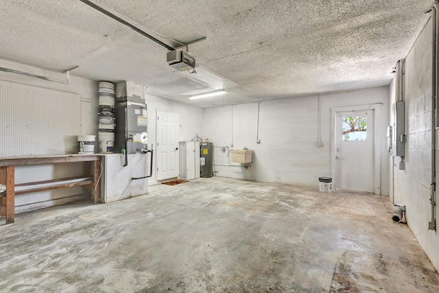 2420 16th St W, Palmetto, FL 34221 - garage featuring a garage door opener, electric water heater, a workshop area, and a sink