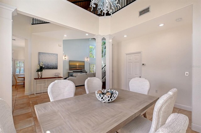 4108 Roberts Point Rd, Sarasota, FL 34242 - dining area with a towering ceiling, decorative columns, baseboards, recessed lighting, and light tile patterned flooring