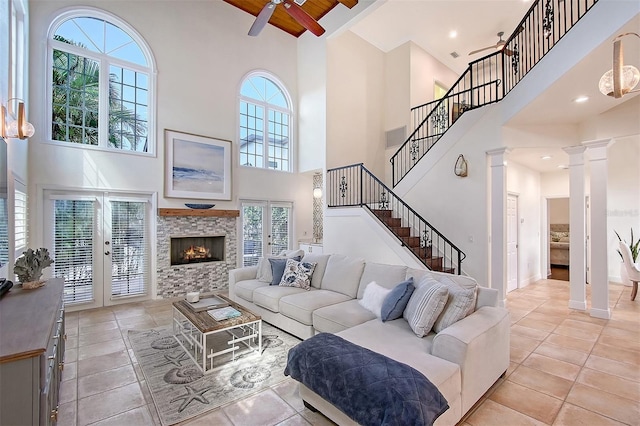 4108 Roberts Point Rd, Sarasota, FL 34242 - living room with high vaulted ceiling, stairway, ceiling fan, light tile patterned floors, and a glass covered fireplace