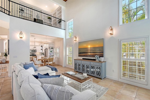 4108 Roberts Point Rd, Sarasota, FL 34242 - living room featuring a high ceiling, baseboards, and tile patterned flooring