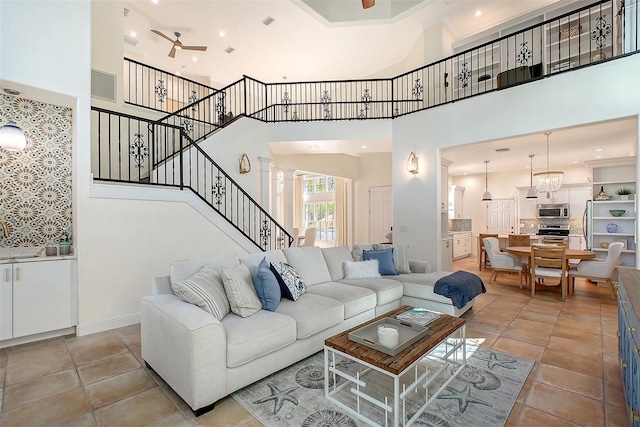 4108 Roberts Point Rd, Sarasota, FL 34242 - living area featuring ceiling fan, stairs, a high ceiling, and light tile patterned floors