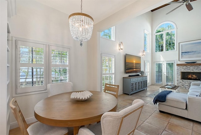 4108 Roberts Point Rd, Sarasota, FL 34242 - dining space with a high ceiling, plenty of natural light, a chandelier, a ceiling fan, and baseboards