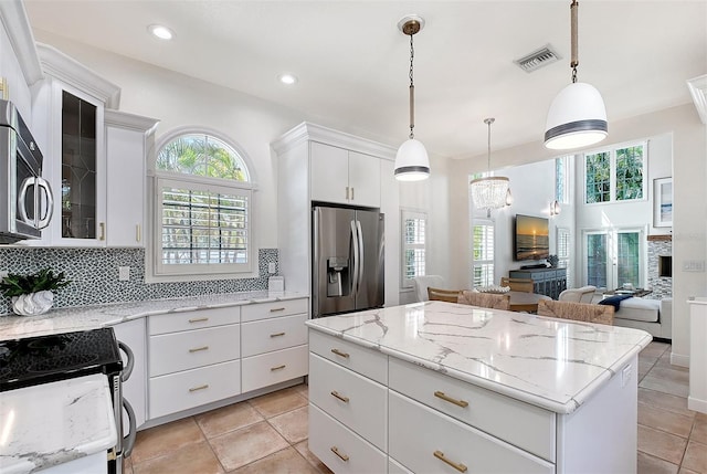 4108 Roberts Point Rd, Sarasota, FL 34242 - kitchen with appliances with stainless steel finishes, plenty of natural light, a center island, glass insert cabinets, and recessed lighting