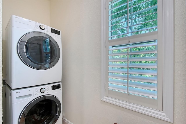 4108 Roberts Point Rd, Sarasota, FL 34242 - laundry area featuring stacked washer / drying machine and a textured wall