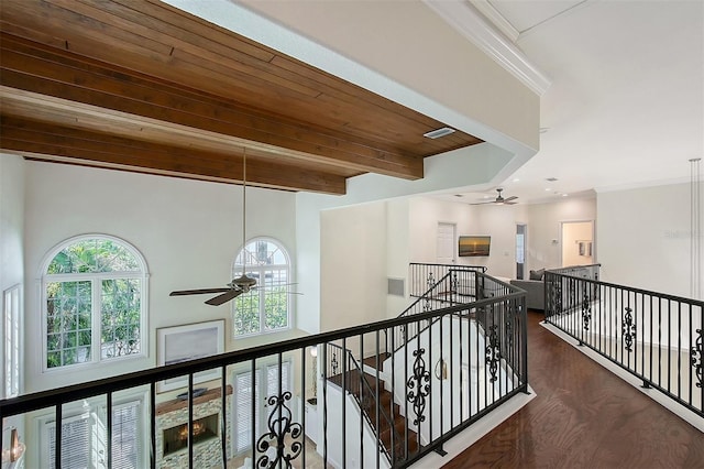 4108 Roberts Point Rd, Sarasota, FL 34242 - hall with healthy amount of natural light, wood finished floors, an upstairs landing, ornamental molding, and wood ceiling with exposed beams