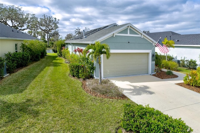 3631 Shimmering Oaks Dr, Parrish, FL 34219 - view of side of property featuring a yard, concrete driveway, an attached garage, and roof mounted solar panels